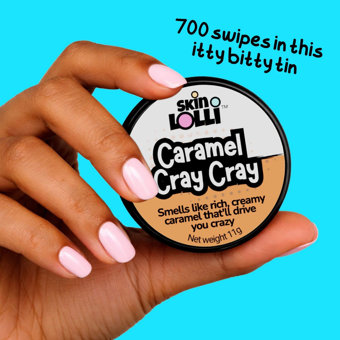 Hand holding Skin Lolli 'Caramel Cray Cray' against a pink background