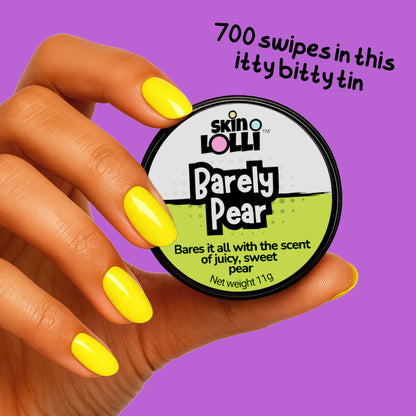 Hand holding a tin of 'Barely Pear' by skin Lollli scent on a purple background.