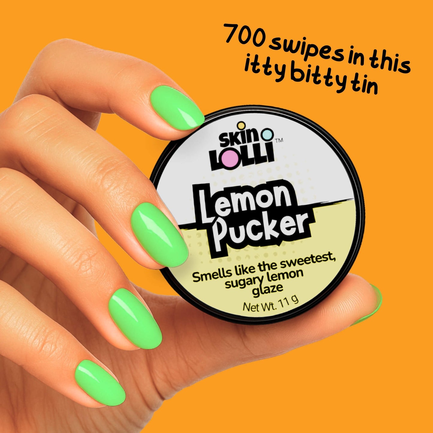 Hand holding a Tin of Skin LOLLI Lemon Pucker swipe on perfume with text, 700 swipes in this itty bitty tin
