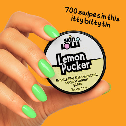 Hand holding a Tin of Skin LOLLI Lemon Pucker swipe on perfume with text, 700 swipes in this itty bitty tin