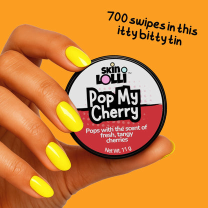 Hand holding a tin of 'Pop My Cherry' by skin LOLLI with text on an orange background that says, 700 swipes in this itty bitty tin