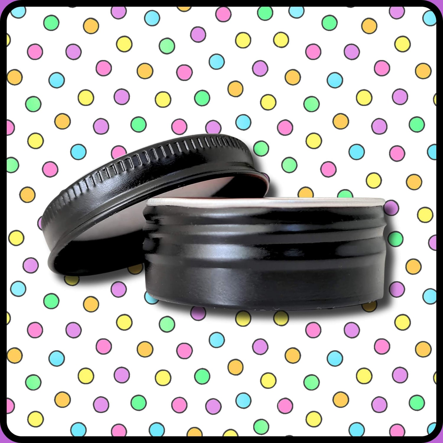 Skin Lolli black aluminium tin with lid sitting off to side against backdrop of candy coloured polka dots