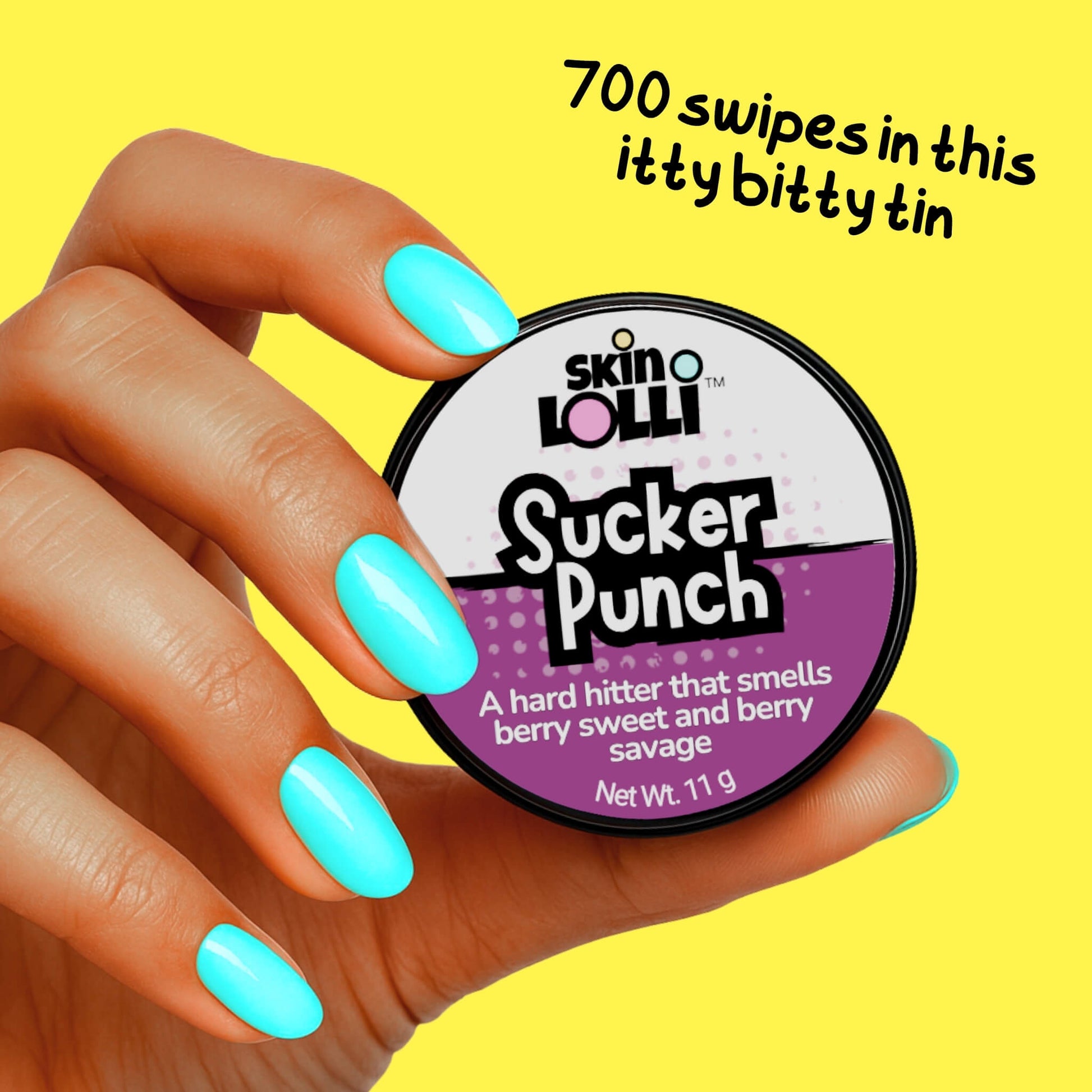 Hand holding tin of skin LOLLI Sucker Punch berry scented swipe on perfume with text that says 700 swipes in this itty bitty tin on a yellow background