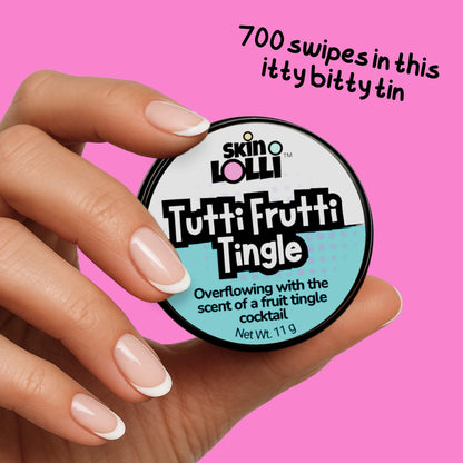Hand holding a container of 'Tutti Frutti Tingle' by skin LOLLI against a pink background. text reads 700 swipes in the this itty bitty tin